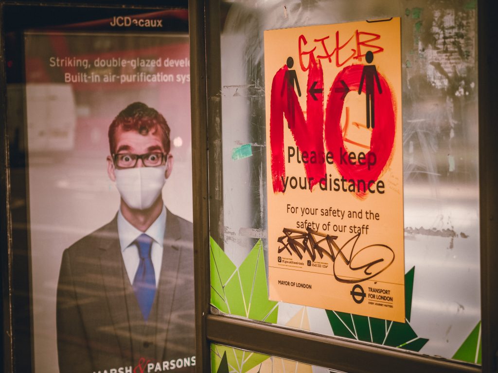 A bus-stop sign in London asks people to be keep their social distance for their own safety and that of the staff. The sign was vandalized with a huge writing that states NO.